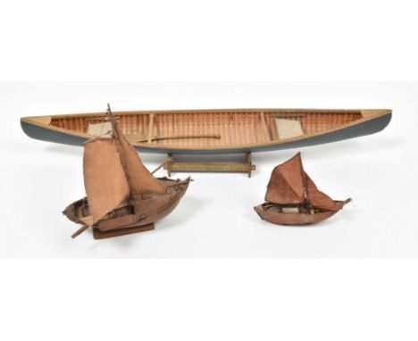 20th cent., length 70 cm, constructed w. (painted) light wood, w. 2 webbing seats, orig. paddle and stand.Paint peeling/ flak