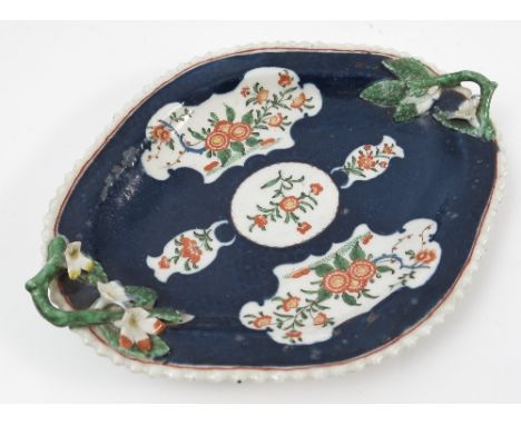 A Worcester porcelain shaped oval dish, the dark blue ground having white ground reserves decorated with flowers, with twig a