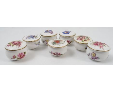 Five Royal Worcester circular covered boxes, hand painted with flowers, one signed, together with a modern pair of Royal Worc