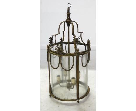 A gilt metal light fitting, decorated with swags and acanthus leaves, with four sliding glass panels, diameter 11ins
