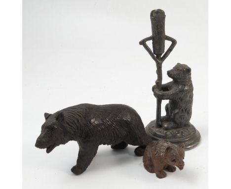 Two black forest carved models, of bears, together with a Victorian metal holder, formed as a seated bear holding a lamp post