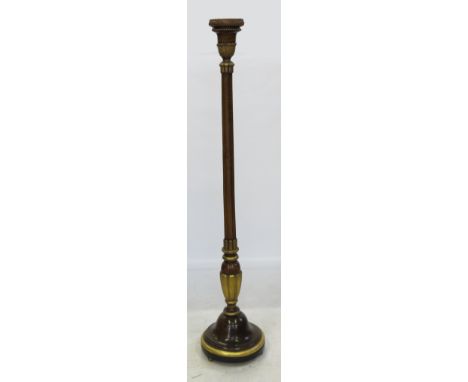 A mahogany and parcel gilt standard lamp, converted to a torchere, with octagonal shaped column with circular base
