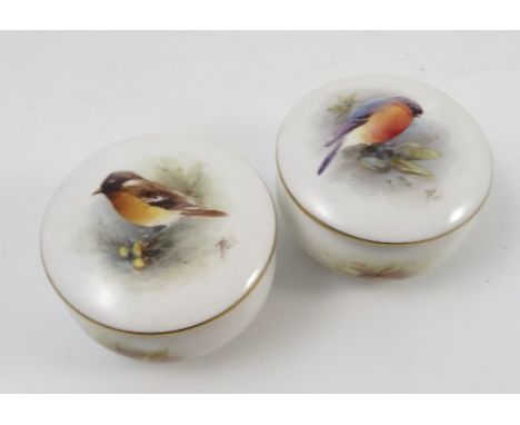Two Royal Worcester circular covered boxes, hand painted with English birds on branches to the covers by T Poole, dated 1956,