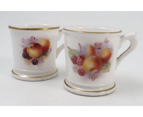 Two Royal Worcester miniature mugs, decorated with fruit to a white ground, dated 1925 and 1926, height 1.5ins