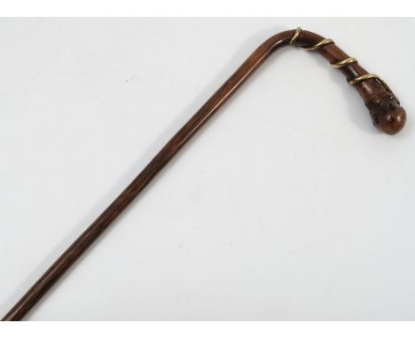 A 19th century hardwood walking stick, with burr pommel, the handle wraped with a gold coloured metal forming a snake, length