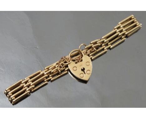 A 9ct gold bracelet, of four bar gate link design, to padlock clasp, weight 14.4g gross
