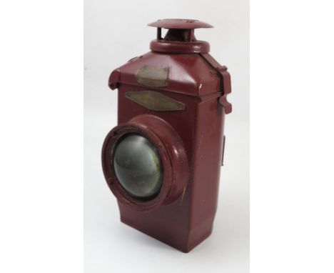 An Adlake non sweating railway lamp, with brass plaques, no.22, patent no. 826558.9, painted red, with burner, height 15.5ins