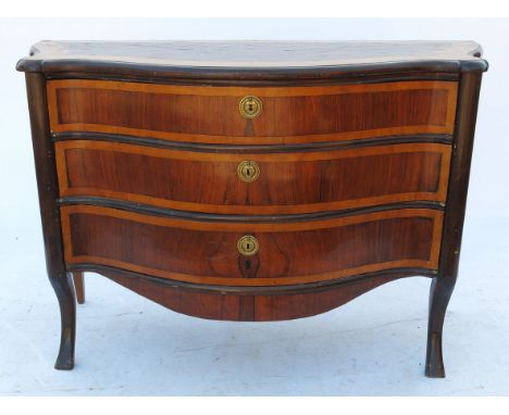 A continental commode, of serpentine outline, having satinwood and rosewood parquetry to top, fitted three cross banded drawe