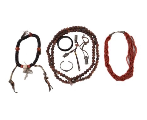 Ω A group of Tibetan jewellery, 19th and 20th century, comprising: a long carved wooden bead mala, a Zitan wood and cornelian