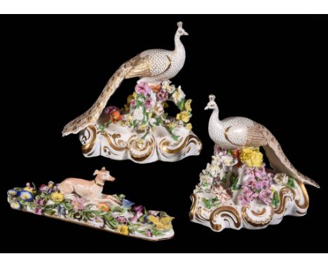  A pair of English porcelain flower encrusted models of peacocks,   circa 1830, Minton or Derby, blue crossed swords marks, 1