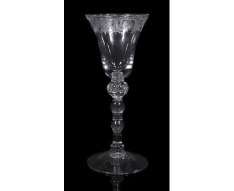  An engraved light baluster goblet of 'Newcastle' type,   mid 18th century, the bell bowl engraved with a band of birds and s