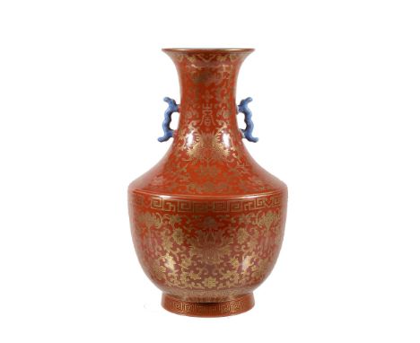  A Chinese coral-ground two-handled vase,   painted in gilt with flower heads and scrolling foliage with bats and with the lo