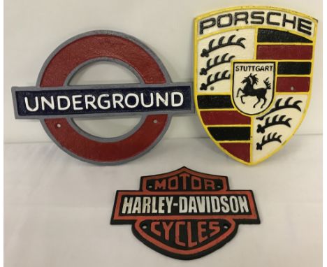 3 painted cast iron wall hanging plaques. Porsche, Underground and Harley-Davidson. Largest approx. 24cm tall.