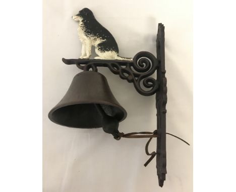 A painted cast iron, wall hanging garden bell with Collie dog detail.  Approx. 37cm tall.