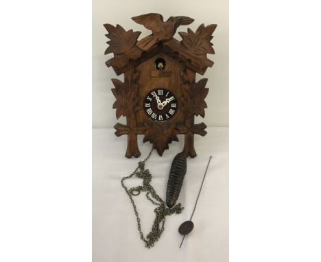 A vintage German cuckoo clock, complete with chain, weight and pendulum.  Case approx. 24cm tall x 18cm wide.