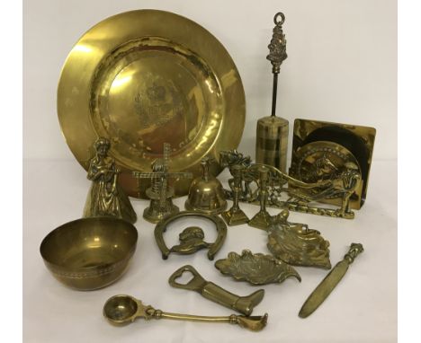 A collection of vintage brassware items. To include: letter rack, miniature candlesticks, bells and bottle opener. 
