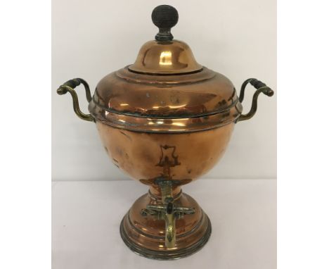 A vintage copper samovar with brass tap and handles.  Approx. 37cm tall.