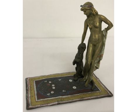 After Bergmann, a cold painted figurine of a nude woman and a panther stood on a floral carpet. Marks to base. Approx. 16.5cm