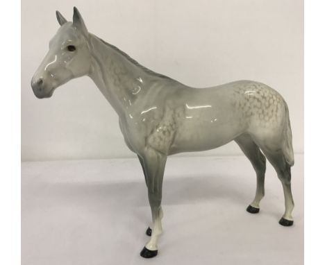 A Beswick ceramic Bois Roussel racehorse figurine in dapple grey. #701 in gloss finish and with circular backstamp. Second ve