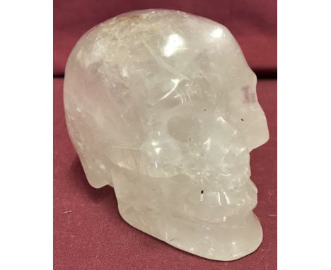 A carved rock crystal ornament in the shape of a skull.  Approx. 10cm tall.