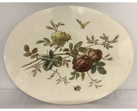 A large oval ceramic plaque with floral and insect decoration. Marked "5 1949 17" to reverse. Approx. 35cm x 26cm.