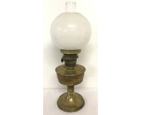 A vintage brass oil lamp with opaque glass shade.  Approx. 60cm tall.