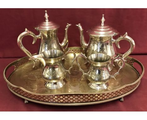 A vintage silver plated tea service. Comprising a large oval two-handled tray with a copper etched floral pattern and claw &a