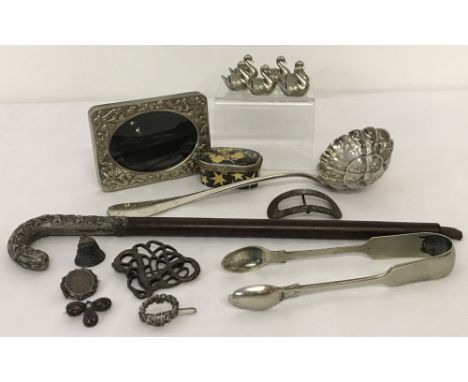 A collection of 16 vintage white metal items. To include: a set of 6 place name swans; a small picture frame; sugar tongs &am