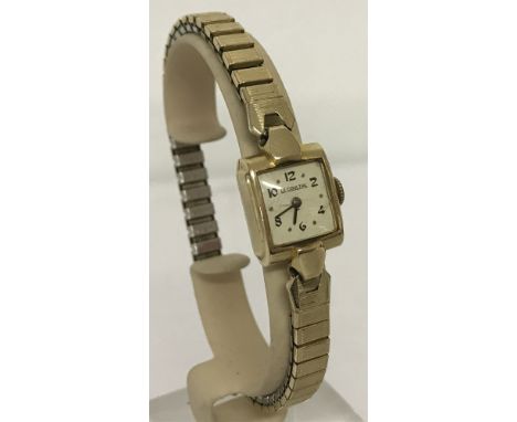 A vintage ladies 10k gold filled wristwatch by Le Coultre, with expandable strap.  