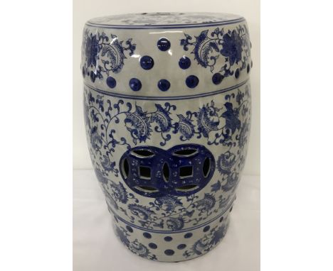 A large ceramic blue and white Oriental seat with floral detail.  Approx. 46cm tall.