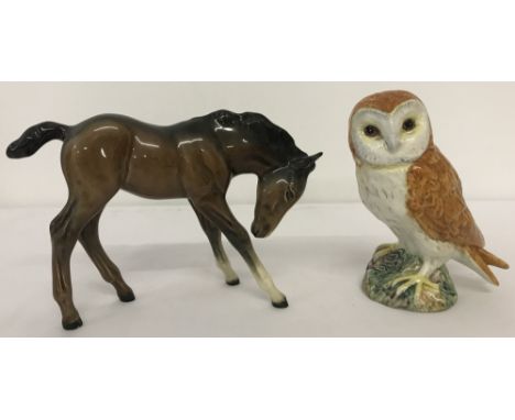 2 Beswick ceramic animal figurines. #947 foal head down in brown gloss with oval backstamp together with an owl #2026. 