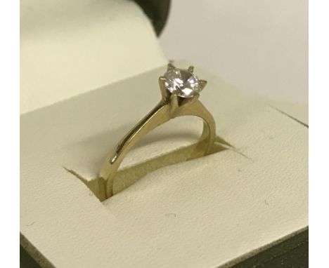 A 9ct gold solitaire dress ring set with round cut central clear stone.  Size K½. Total weight approx. 2.2g.