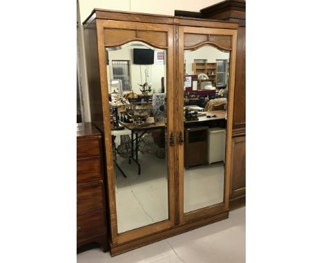 A vintage heavy oak 2 door double wardrobe with mirrored doors. Shelf, hanging rail and hooks to interior on each side. Appro