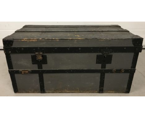 A vintage 2 handled, metal banded, travelling trunk.  Approx. 42cm tall x 86cm long.