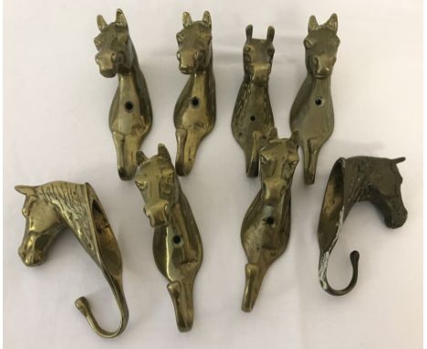 A collection of 8 vintage brass wall hanging hooks in the shape of horses heads.  Each approx, 16cm long.