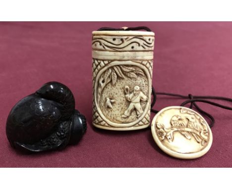 A highly carved Japanese Inro depicting oriental figures with attached button netsuke. Together with a carved dark wood Japan