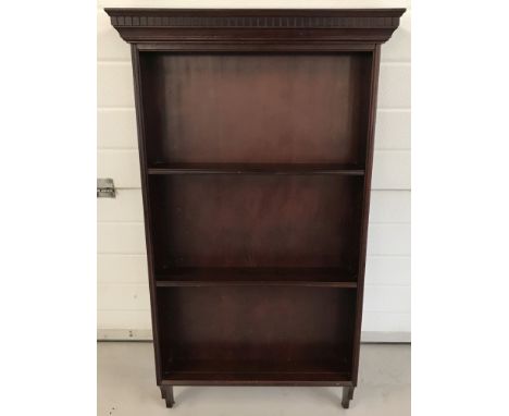 A modern mahogany coloured wall hanging shelf with carved detail to top. 3 shelves with plate grooves. Approx. 113cm tall x 6