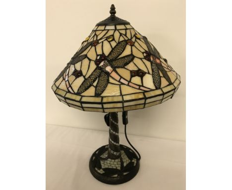 A tiffany style table lamp with leaded glass shade and lamp base. Dragonfly detail to shade and base. Approx. 58cm tall.