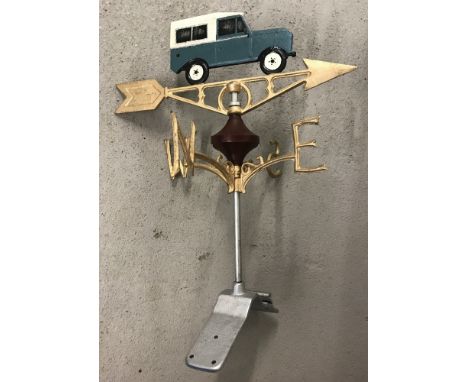 A modern painted cast metal weather vane with Land Rover detail. Complete with fixing plate. Approx. 60cm tall.