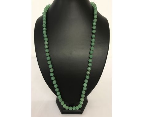 A 28" jade beaded necklace, knotted between each bead.  Beads approx. 1cm diameter.