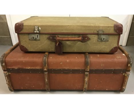 A vintage wooden banded travelling trunk together with a fabric and leather military issue suitcase.  