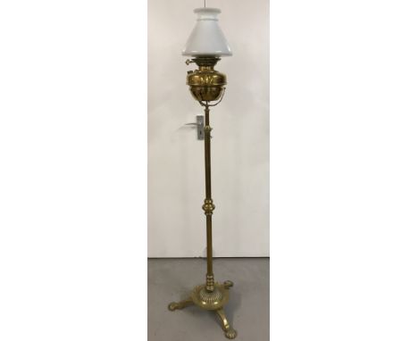 An antique brass Veritas floor standing oil lamp complete with white glass shade.  