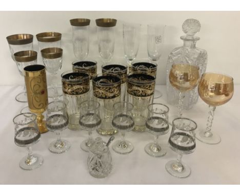 A quantity of assorted glassware to include a heavily cut crystal decanter. Together with pairs of champagne flutes, a set of