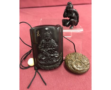 A lacquered Japanese Inro and netsuke. Together with and erotic netsuke of a oriental lady bathing. The Inro has carved detai
