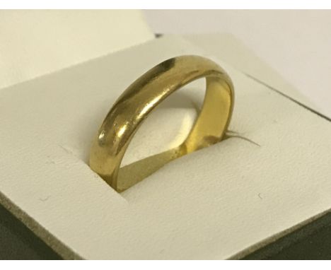 A vintage 22ct gold wedding band. Size T. Total weight approx. 7.1g.