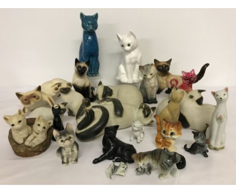 A collection of ceramic cats in a variety of sizes. Including 5 Moorside Siamese (some a/f), Goebel and Atelier Scarlett. 