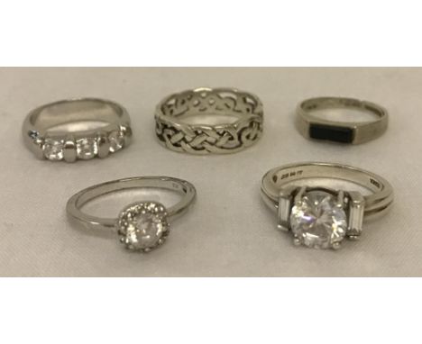 5 silver dress rings. Comprising: central round cut cubic zirconia with a baguette cut cubic zirconia either side, a band set