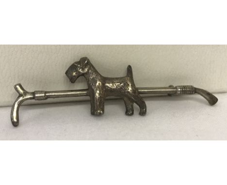 A vintage silver brooch in the shape of a riding crop with Airedale terrier decoration. Marked silver to back. 