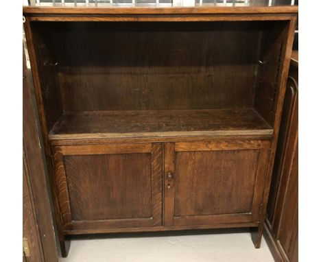 A vintage dark oak 2 door bookcase with adjustable shelf to top.  Approx. 107cm tall x 94cm wide.