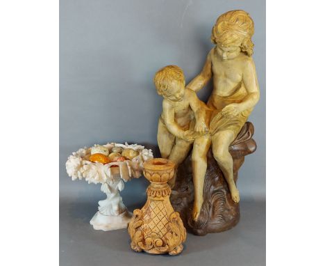 An Alabaster comport together with a collection hand warmers in the form of eggs, a composition group, a similar candlestick 